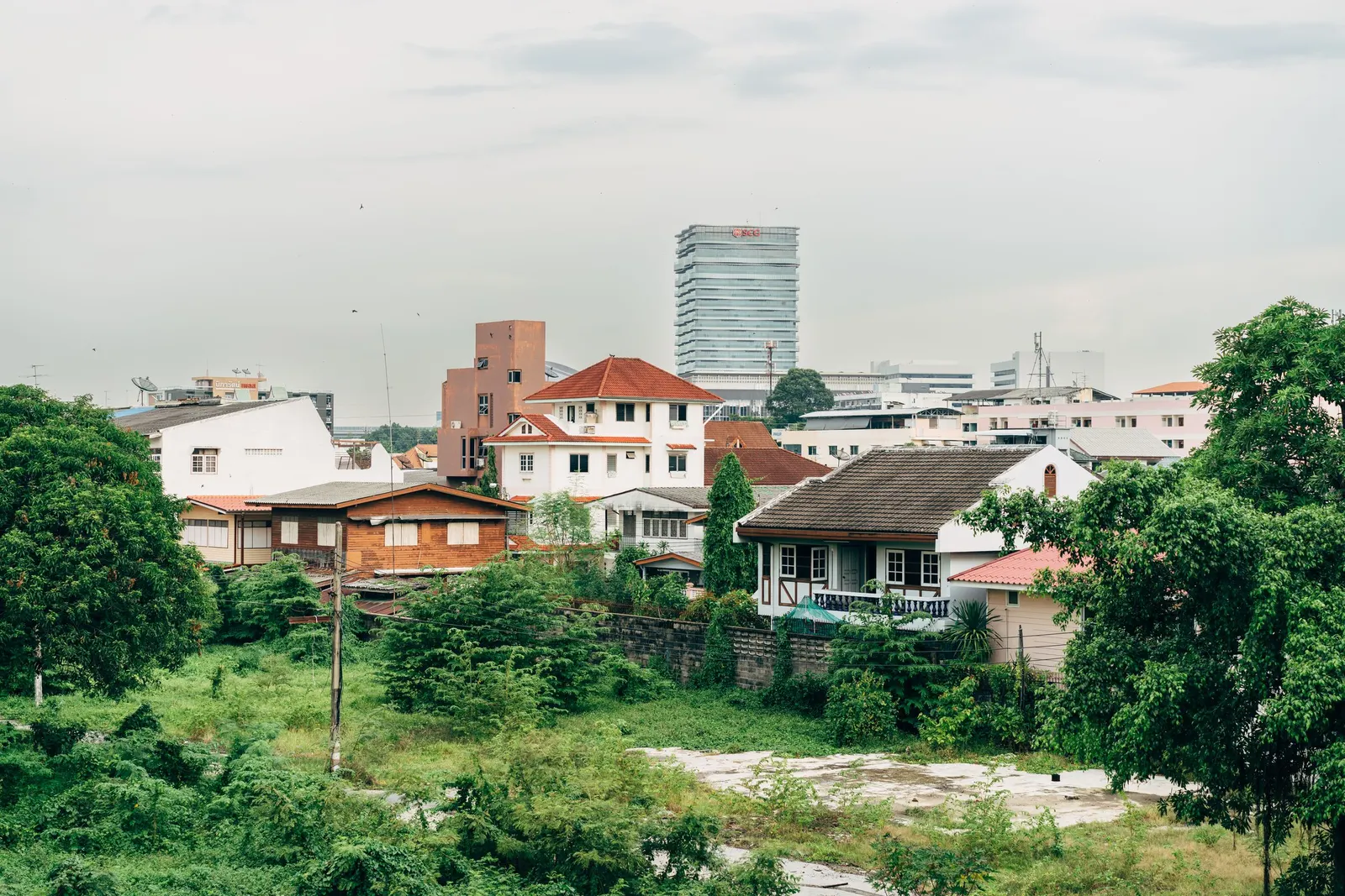 Suburban houses in the foreground with a city skyline behind them